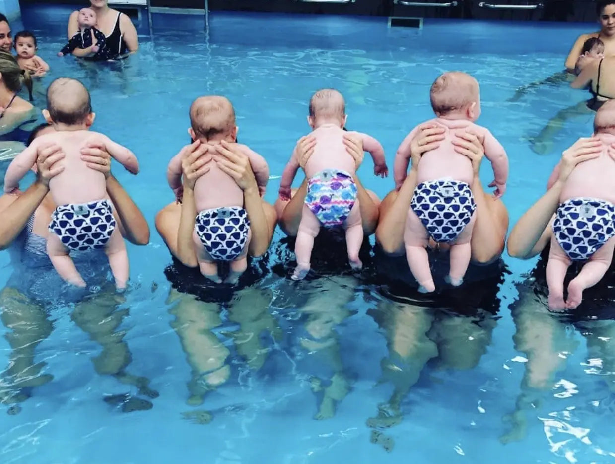 Parents swimming with kids, using reusable swim nappies