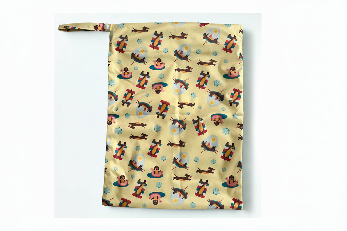 Wet bag  for swimming with a colourful pattern of cartoon dogs on a yellow background