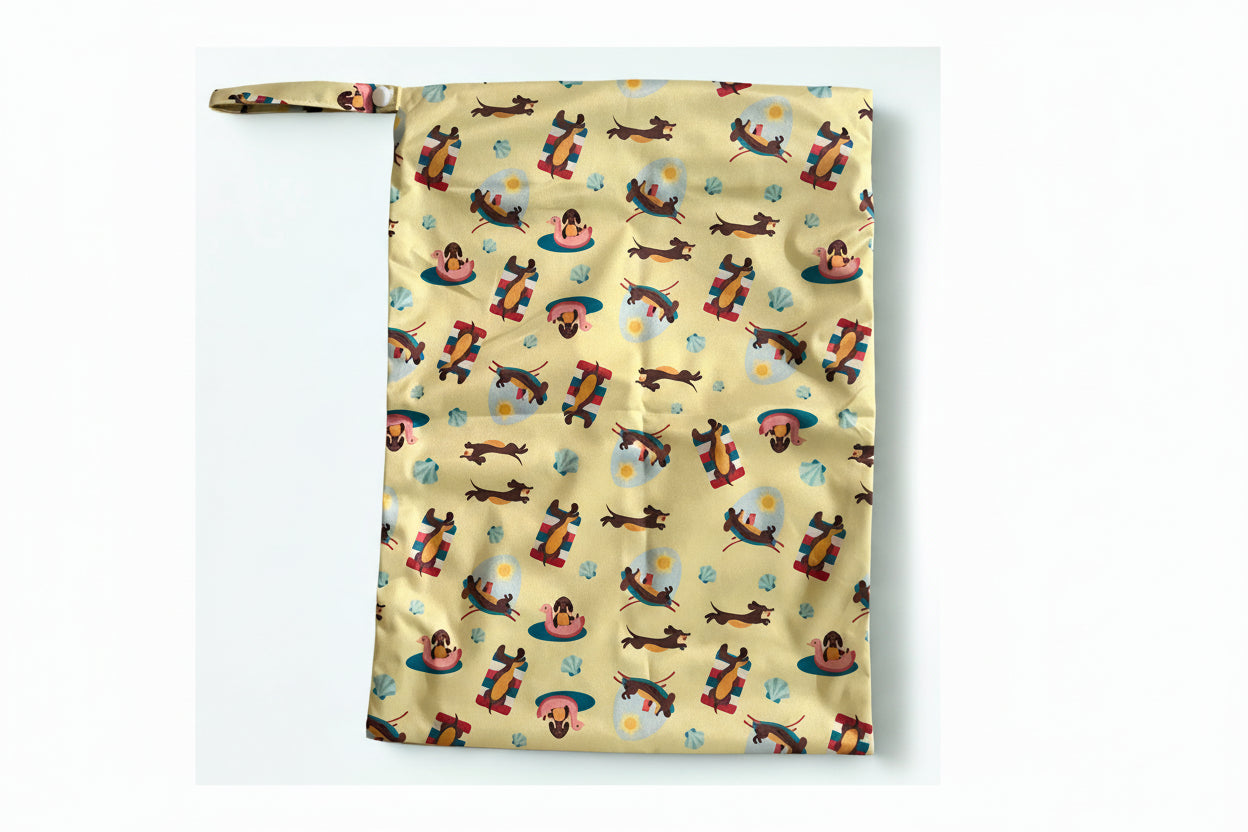 Wet bag  for swimming with a colourful pattern of cartoon dogs on a yellow background